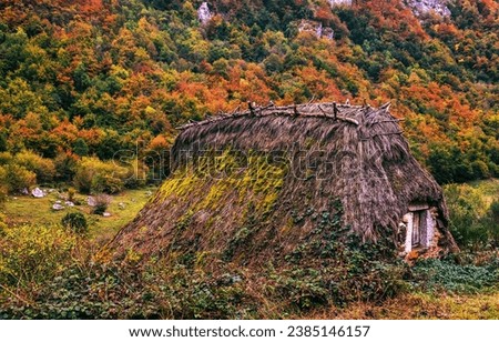 A dugout in the autumn mountains. Dugout in autumn. Autumn forest hut. Forest hut in autumn