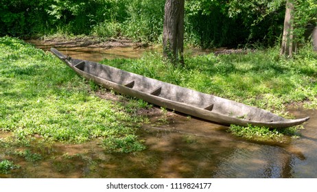 Dugout Canoe Prop On Edge Of Water Flow