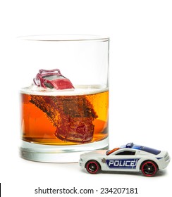 DUI Concept. Image Of A Drunk Driving Accident Inside A Small Glass With Beer Isolated On A White Background