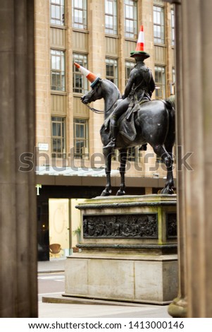 Duke of Wellington statue in Glasgow with travel cones on the head of the Duke and the horse.