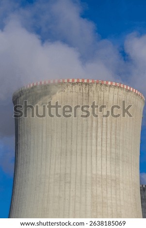 Dukovany Nuclear Power Plant in the Czech Republic, Europe. Smoke cooling towers. There are clouds in the sky. In the background the nature of the Highlands.