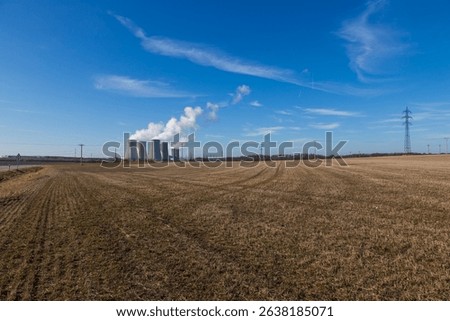 Dukovany Nuclear Power Plant in the Czech Republic, Europe. Smoke cooling towers. There are clouds in the sky. In the background the nature of the Highlands.