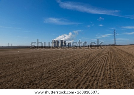 Dukovany Nuclear Power Plant in the Czech Republic, Europe. Smoke cooling towers. There are clouds in the sky. In the background the nature of the Highlands.