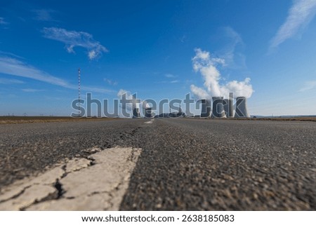 Dukovany Nuclear Power Plant in the Czech Republic, Europe. Smoke cooling towers. There are clouds in the sky. In the background the nature of the Highlands.