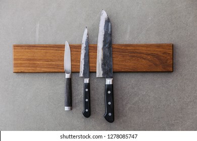 Dull Japanese Kitchen Knives Stick On Magnet Cover With Wood On Concrete Wall.