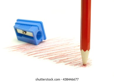 Dull  Pencil With Blue Pencil Sharpener On A White Background