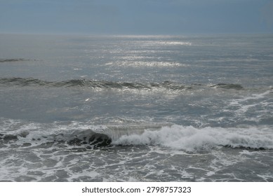 The dull sky and the lapping waves
