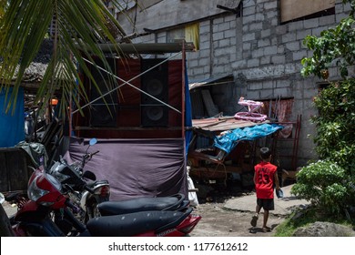 Dumaguete, The Philippines - 10 September 2018: People Celebrating Local Festival Fiesta. Little Boy Walk Outdoor. Stereo System On Backyard. Filippino Daily Life. Traditional Fiesta Celebration.