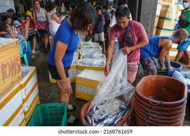 Dumaguete, Philippines - June 2022: Fish sellers in the Dumaguete market on June 17, 2022 in Negros Oriental, Philippines.
