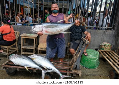 Dumaguete, Philippines - June 2022: A man selling tuna in the Dumaguete market on June 17, 2022 in Negros Oriental, Philippines.