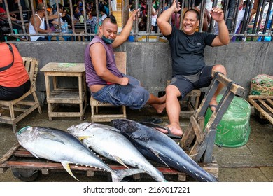 Dumaguete, Philippines - June 2022: Men selling tuna in the Dumaguete market on June 17, 2022 in Negros Oriental, Philippines.