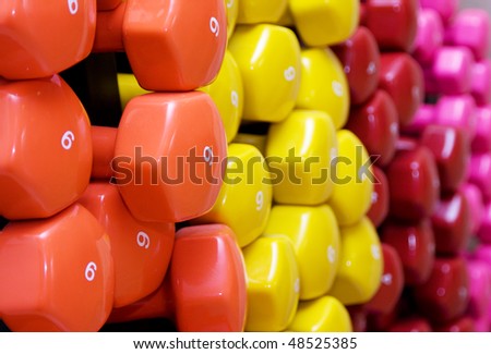 dumbbell, barbell. Background of many color weights