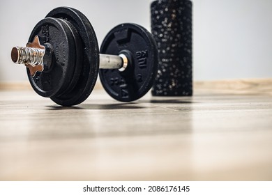 A Dumbbell For Exercises And A Back Roller Waiting For Training. Home Fitness And Motivation . No Person. New Year's Resolutions

