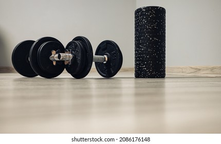 A Dumbbell For Exercises And A Back Roller Waiting For Training. Home Fitness And Motivation . No Person. New Year's Resolutions

