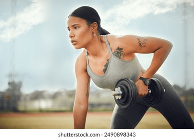 Dumbbell, fitness and weightlifting with woman outdoor in park for bodybuilding, training or workout. Exercise, equipment and power with strong athlete on field for challenge, health or performance - Powered by Shutterstock