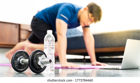 Dumbbell And Mature Asian Man Doing Exercises At Home In Background. Workout At Home. Social Distancing.