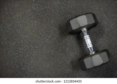 Dumbbell On Black Rubber Floor In Gym For Exercise.