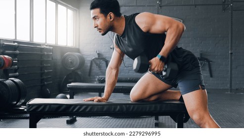 Dumbbell row, fitness and man in a gym strength training, bodybuilding exercise and powerful workout. Healthy, motivation and strong bodybuilder athlete rowing with heavy weights for strong arms - Powered by Shutterstock