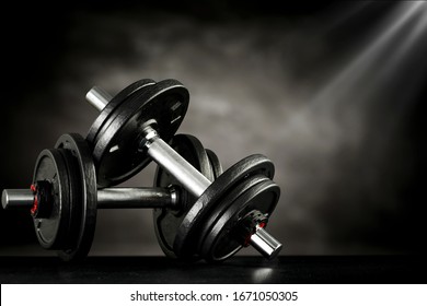 Dumbbells and gym interior.Free space for your decoration and black bench.Copy space for your products. 