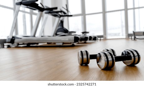 dumbbells in the gym on the floor, the concept of proper nutrition and fitness, a place for the inscription - Powered by Shutterstock