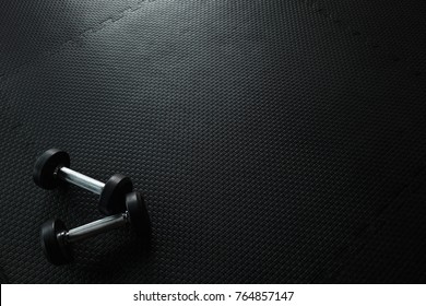 Dumbbells On Empty Floor In Gym