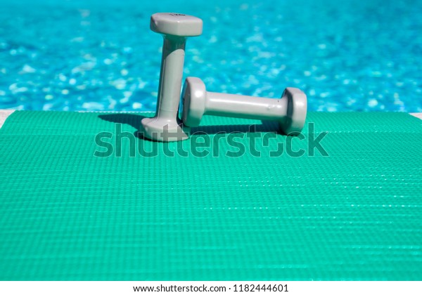 Dumbbells On Mat Pool Behind Stock Photo Edit Now 1182444601