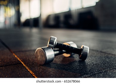 Dumbbells on rubber floor closeup, fitness club