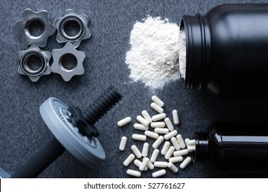 Dumbbells, Protein And Amino Acids On A Gray Background