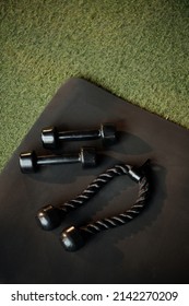 Dumbbells And Triceps Rope On Gym Floor, View From Above