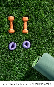 Dumbbells, Yoga Mat, Weights On A Green Grass. Top View. Concept Fitness Outside, Sport, Healthy Lifestyle, Well Being, Home Gym. Sunny Day. Park, Outdoor. Copy Space. Top View. Nobody