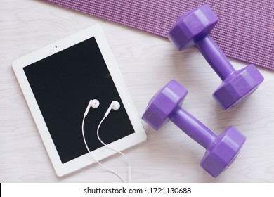 Dumbell And Tablet On Yoga Mat. Concept Of Workout At Home,online Workout,home Excercise.