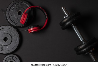 Dumbells, Red Headphones On Dark Background.