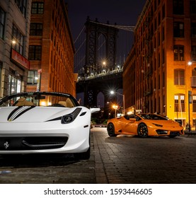 DUMBO Brooklyn, New York 2018.07.24 White Ferrari 458 and Orange Lamborghini Huracan on the cobble stone.