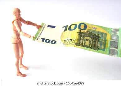 Dummy holding 100 euro banknote. Money or business concept. Abstract conceptual image - Shutterstock ID 1654564399