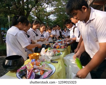 Dumnoensaduak, Ratchburi/Thailand - Dec. 4, 2018 : Thai Students In Secondary School Offering Food To The Monk Alm Bowl For Buddhist Monks, Making Merit For Their Fathers On Fathers Day