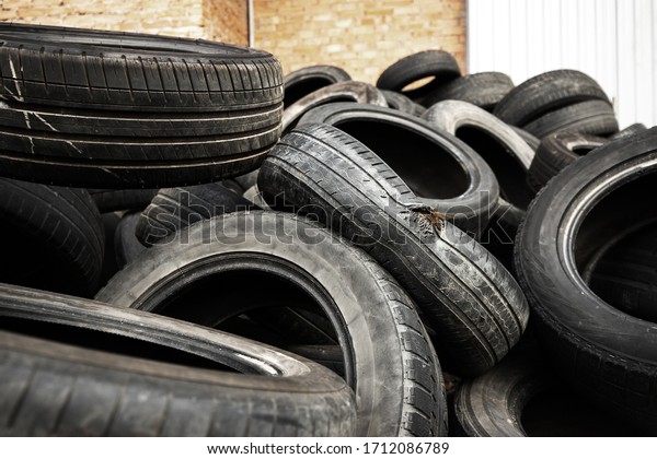 dump of old used car\
tires with holes
