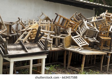 Dump old wooden chairs and vintage chairs, thrown into the street. The big garbage of old destroyed chair/table