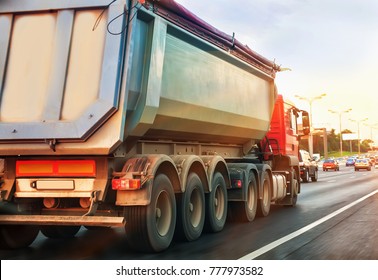 Dump Truck Goes In The Evening On Highway