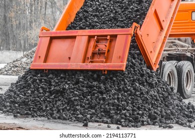 Dump truck in the industrial zone unloads coking coal from the body. - Shutterstock ID 2194113771