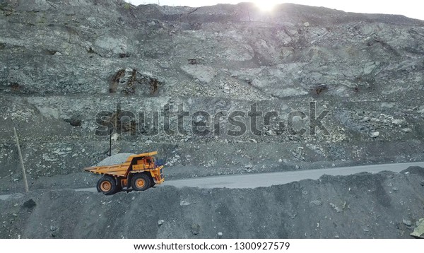 Dump truck loaded with chalk moving on a\
quarry road. Quarry and mining\
equipment.