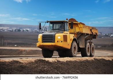 The dump truck is loaded with sand