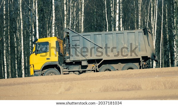 Dump truck in the process of road construction,\
ground works