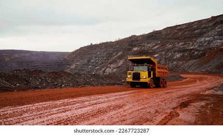 dump truck transporting iron ore in red iron ore quarry. The red quarry looks like the planet Mars          - Shutterstock ID 2267723287