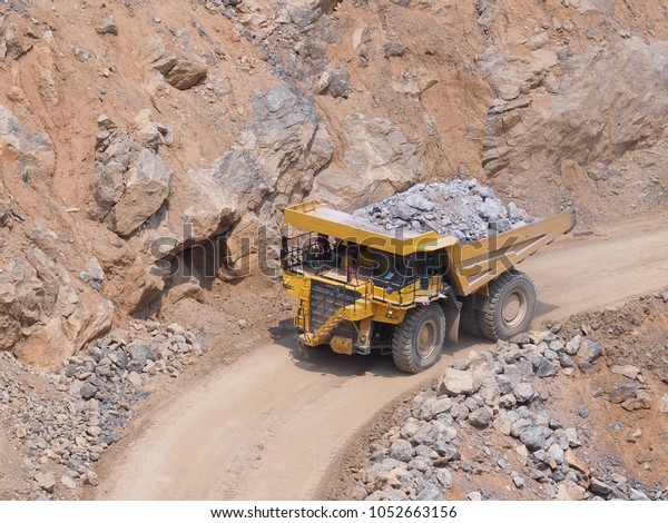 Dump truck\
transports limestone in\
quarry.