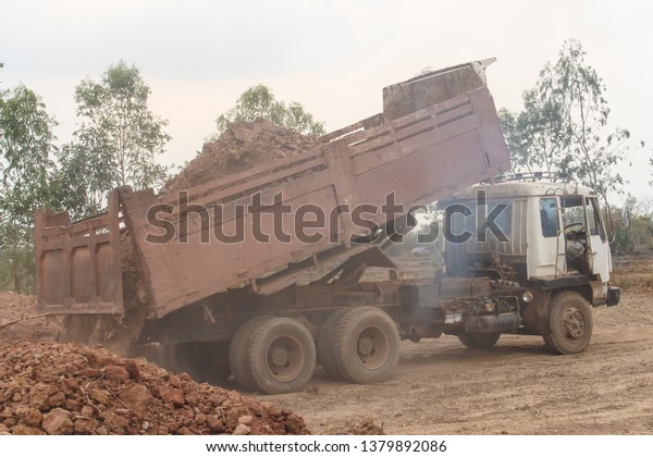 Dump truck unloading soil or\
sand