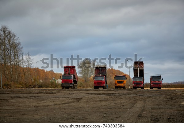 dump trucks in the parking\
lot