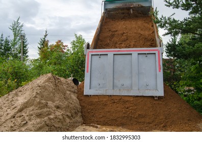 Dumper Truck Unloading Soil Or Sand At Construction Site 