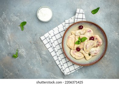 dumplings with cherries, Pierogi, varenyky, vareniki, pyrohy on a light background, banner, menu, recipe place for text, top view,
