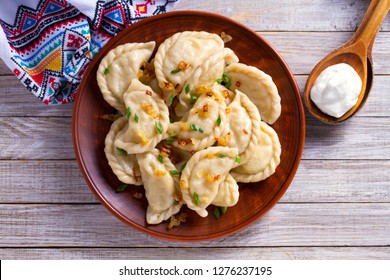 Dumplings, filled with cabbage. Varenyky, vareniki, pierogi, pyrohy - dumplings with filling. View from above, top studio shot