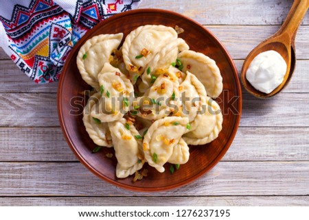 Dumplings, filled with cabbage. Varenyky, vareniki, pierogi, pyrohy - dumplings with filling. View from above, top studio shot